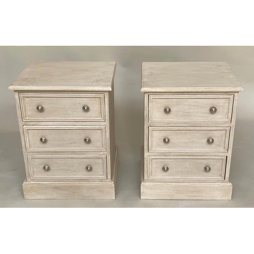 556 - BEDSIDE CHESTS, a pair, traditionally grey painted each with three drawers, 57cm W x 40cm D x 60cm H... 