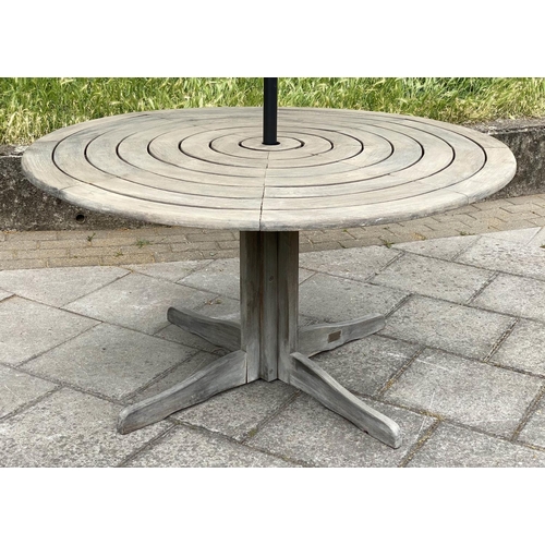 107 - CIRCULAR GARDEN TABLE, weathered teak with circular concentric slatted top and centre column support... 