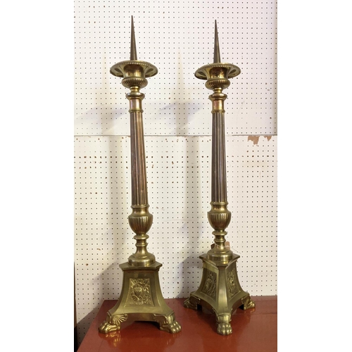 17 - PRICKET CANDLESTICKS, a pair, each 98cm tall, brass Ecclesiastical style. (2)