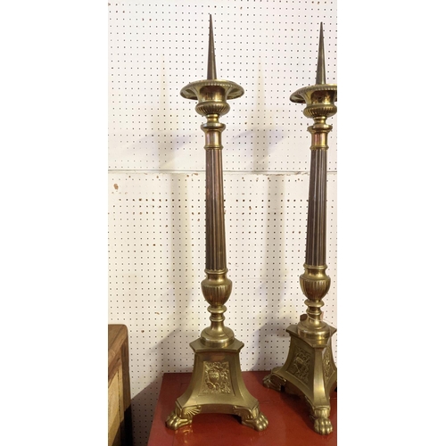 17 - PRICKET CANDLESTICKS, a pair, each 98cm tall, brass Ecclesiastical style. (2)