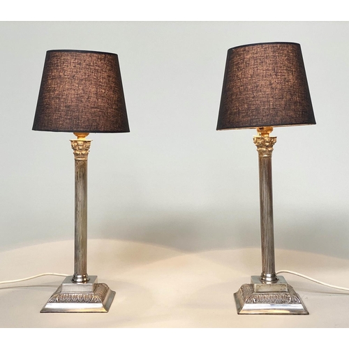 85 - TABLE LAMPS, a pair, silvered each with Corinthian capped reeded column with shades, 50cm H. (2)