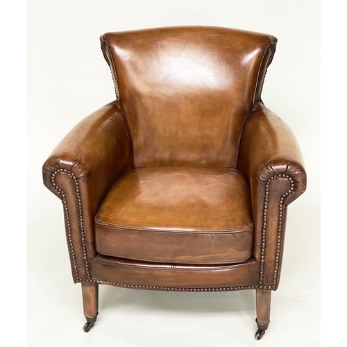 118 - ARMCHAIR, brass studded tan brown leather with rounded back and arms and tapering supports with cast... 