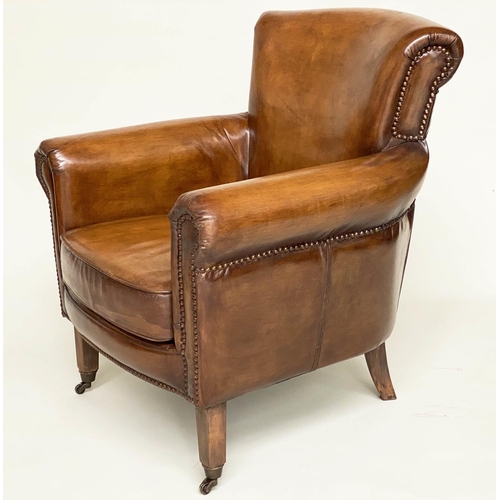 118 - ARMCHAIR, brass studded tan brown leather with rounded back and arms and tapering supports with cast... 