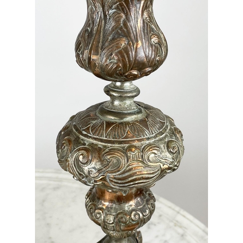 19 - ECCLESIASTICAL PRICKET CANDLESTICS, a pair, ornately embossed silvered copper, 75cm H. (2)