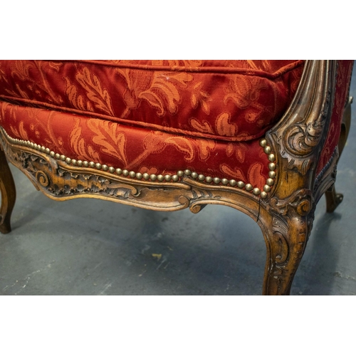 136 - BERGERE A OREILLE, 19th century French walnut with carved frame, red foliage patterned damask uphols... 