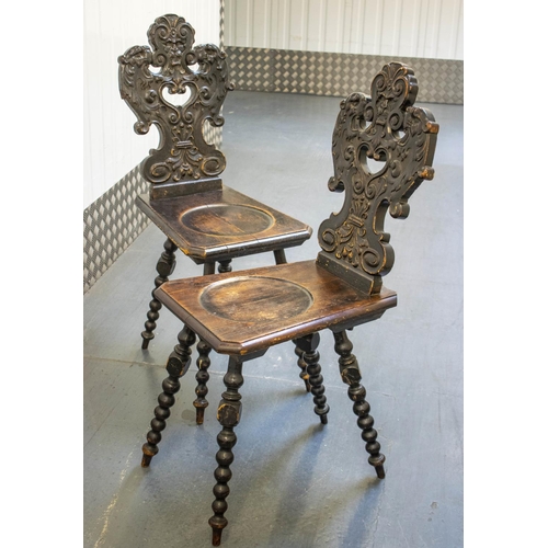 159 - HALL CHAIRS, 98cm H x 38cm W, a pair, 19th century Continental ebonised pine with grotesque carved b... 