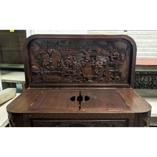 144 - CHINESE BAR, 104cm H x 91cm W 44cm D, with a rising lid and fall front heavily carved all over.