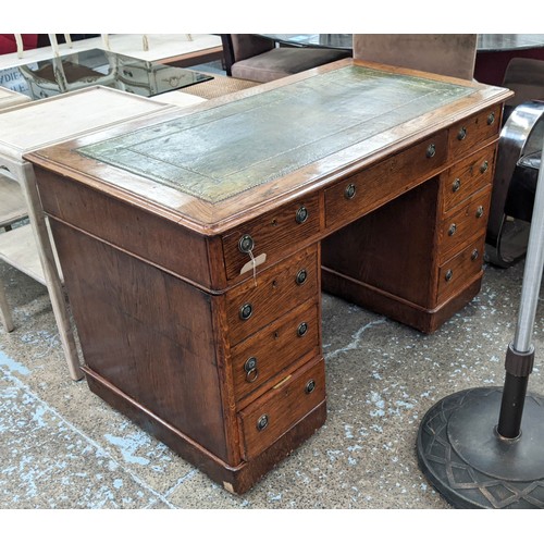 132 - PEDESTAL DESK, 76cm H x 120cm W x 64cm D, Victorian oak with green leather top and nine drawers on c... 