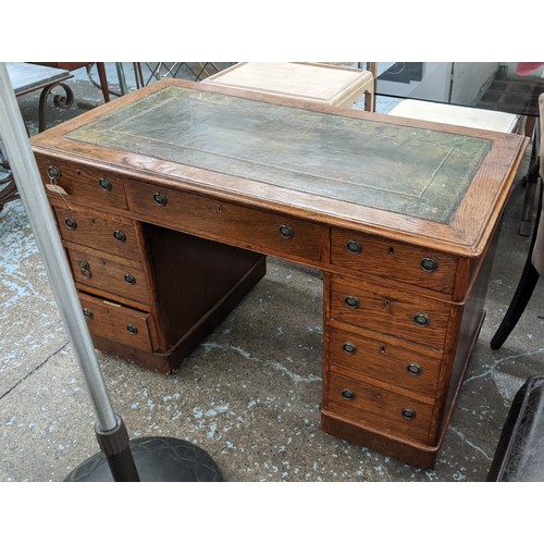 132 - PEDESTAL DESK, 76cm H x 120cm W x 64cm D, Victorian oak with green leather top and nine drawers on c... 