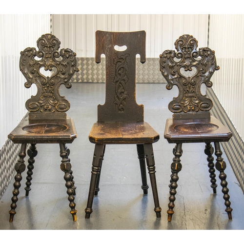 137 - HALL CHAIRS, 98cm H x 38cm W, a pair, 19th century Continental ebonised pine with grotesque carved b... 