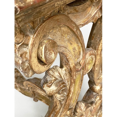 130 - CONSOLE TABLE, Italian carved giltwood with C scroll trestles united by a shaped stretcher and inset... 