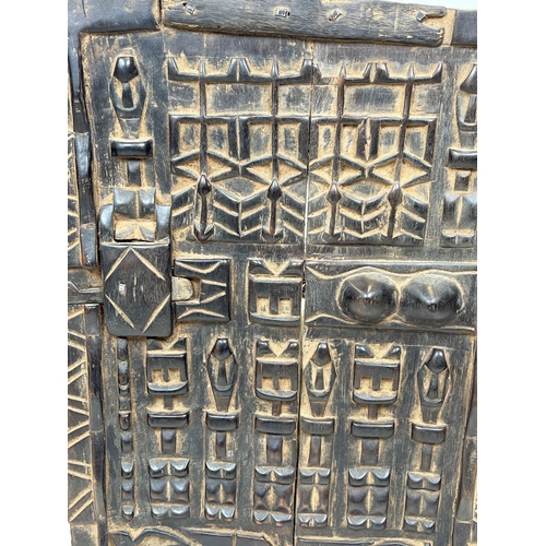 3 - DOGON GRANARY DOOR, Mali, with symbolic raised carved decoration, 65cm H x 43cm W.