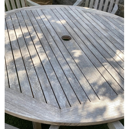 489 - CIRCULAR GARDEN TABLE AND CHAIRS, silvery weathered teak, including a set of six armchairs by Lister... 