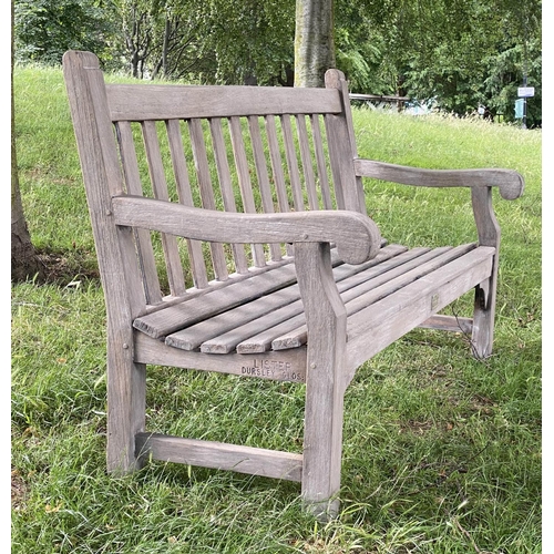 493 - LISTER GARDEN BENCH, well weathered teak of Country House proportions, slatted with scroll arms, R A... 