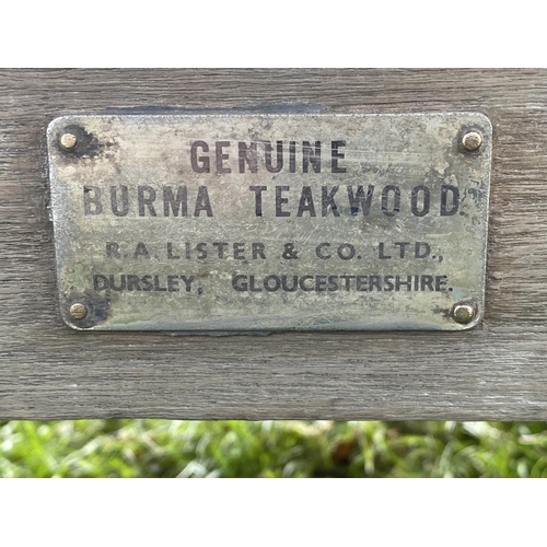 493 - LISTER GARDEN BENCH, well weathered teak of Country House proportions, slatted with scroll arms, R A... 