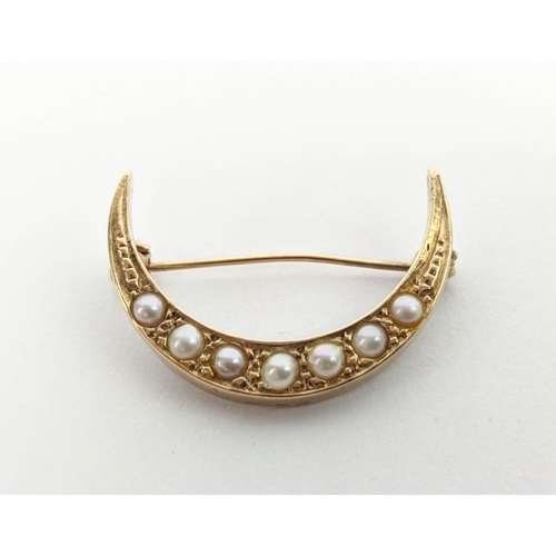 7 - A 9CT GOLD CRESCENT MOON BROOCH, set with seed pearls; a pair of 9ct gold ruby set stud earrings, wi... 