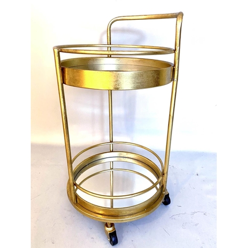 384 - COCKTAIL TROLLEY, 77cm high, 42cm diameter, 1960s French style, mirrored glass tiers, gilt metal fra... 