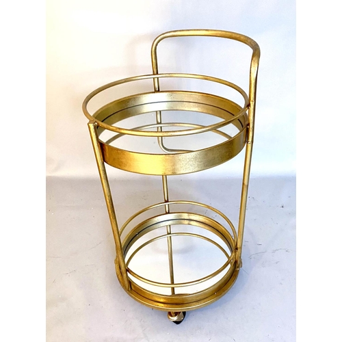 384 - COCKTAIL TROLLEY, 77cm high, 42cm diameter, 1960s French style, mirrored glass tiers, gilt metal fra... 