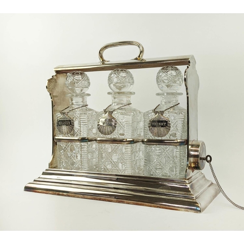 7 - A WALKER AND HALL SILVER PLATED TANTALUS fitted with three square cut glass decanters, carrying hand... 