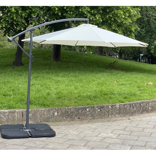 125 - GARDEN PARASOL, circular cream canvas retractable wind up with frame and weights (water filled), 30c... 