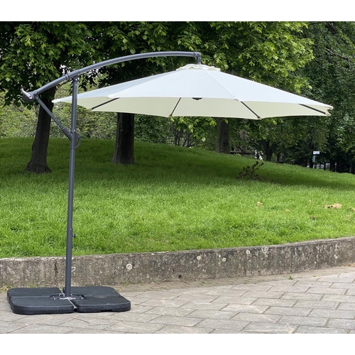 125 - GARDEN PARASOL, circular cream canvas retractable wind up with frame and weights (water filled), 30c... 