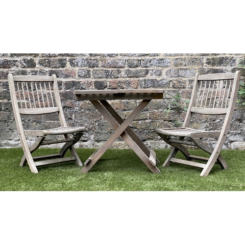 129 - CHILD'S GARDEN ARMCHAIRS, a pair, weathered teak, folding with spindle back together with a lattice ... 