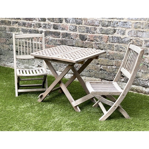 129 - CHILD'S GARDEN ARMCHAIRS, a pair, weathered teak, folding with spindle back together with a lattice ... 