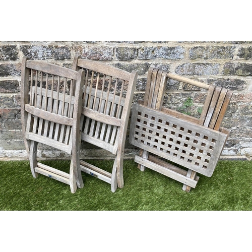 129 - CHILD'S GARDEN ARMCHAIRS, a pair, weathered teak, folding with spindle back together with a lattice ... 