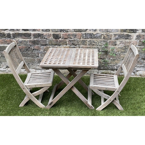 129 - CHILD'S GARDEN ARMCHAIRS, a pair, weathered teak, folding with spindle back together with a lattice ... 