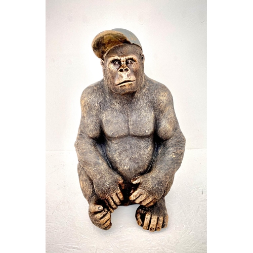 392 - GORILLA WEARING A BASEBALL CAP, 60cm H x 40cm W x 34cm D, faux bronze finish resin.