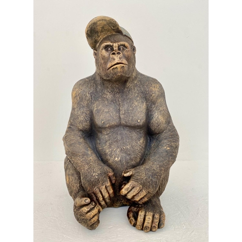 392 - GORILLA WEARING A BASEBALL CAP, 60cm H x 40cm W x 34cm D, faux bronze finish resin.