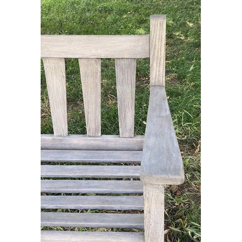 126 - GARDEN BENCH, weathered teak with triangular splat back, 140cm W.