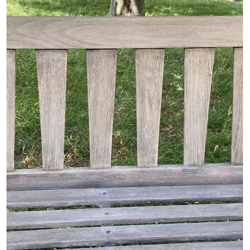 126 - GARDEN BENCH, weathered teak with triangular splat back, 140cm W.