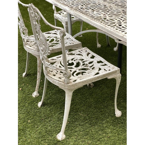 127 - GARDEN TABLE AND CHAIRS, weathered cast aluminium with pierced table and six matching chairs, one wi... 