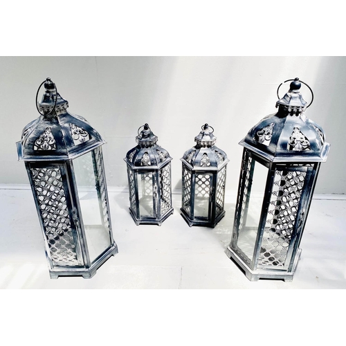 423 - STORM LANTERNS, two graduated pairs, largest measuring 63cm high, 26cm diameter, painted metal. (4)