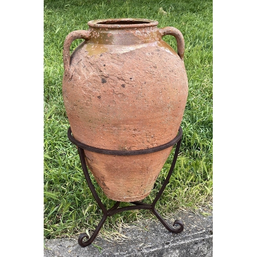 130 - OLIVE JAR ON STAND, antique Mediterranean terracotta on wrought iron stand, 80cm H.