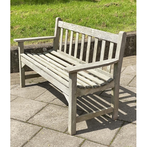 411 - LISTER GARDEN BENCH, silvery weathered teak of slatted construction with flat top arms by R A Lister... 