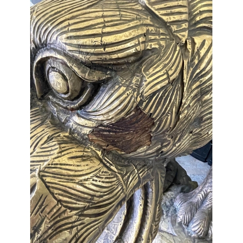 10 - TIGER, of large proportions, carved wood with brass cladding mounted on rock effect base, 245cm L x ... 