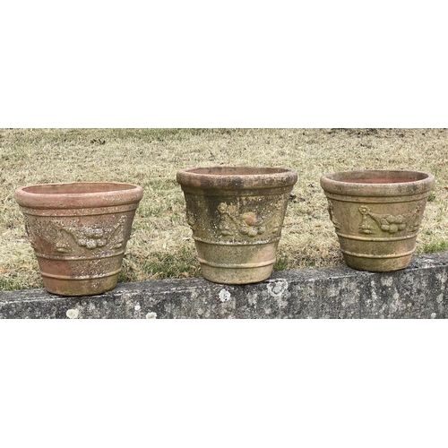 117 - GARDEN TERRACOTTA PLANTERS, a set of three, large weathered terracotta with fruit decoration, 57cm W... 