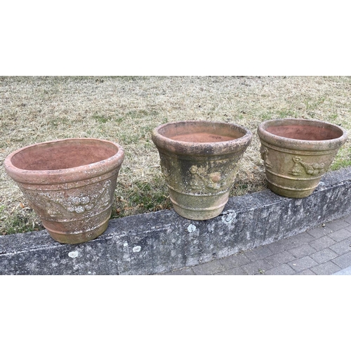 117 - GARDEN TERRACOTTA PLANTERS, a set of three, large weathered terracotta with fruit decoration, 57cm W... 