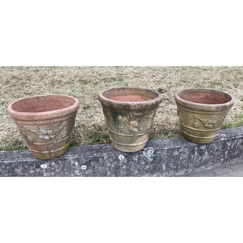 117 - GARDEN TERRACOTTA PLANTERS, a set of three, large weathered terracotta with fruit decoration, 57cm W... 