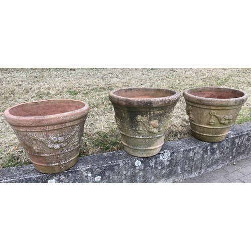 117 - GARDEN TERRACOTTA PLANTERS, a set of three, large weathered terracotta with fruit decoration, 57cm W... 