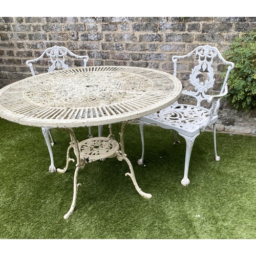 168 - GARDEN TABLE AND CHAIRS, weathered painted cast aluminium circular pierced with two matching chairs,... 