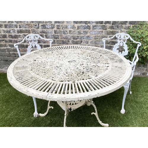 168 - GARDEN TABLE AND CHAIRS, weathered painted cast aluminium circular pierced with two matching chairs,... 