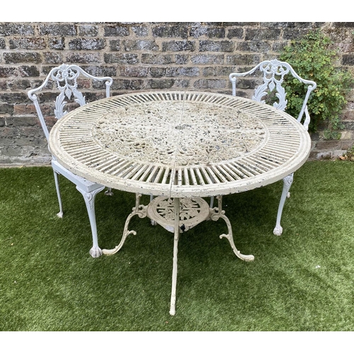 168 - GARDEN TABLE AND CHAIRS, weathered painted cast aluminium circular pierced with two matching chairs,... 