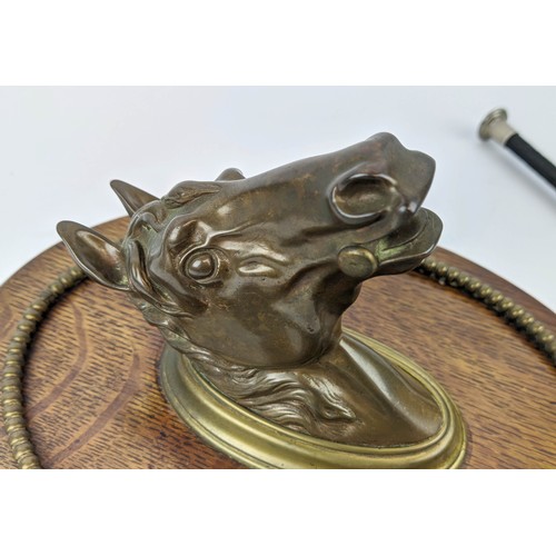 6 - A WALL MOUNTED RIDING GRIP HOOK, cast bronze bust of a horse, oak plaque, 19th/early 20th century