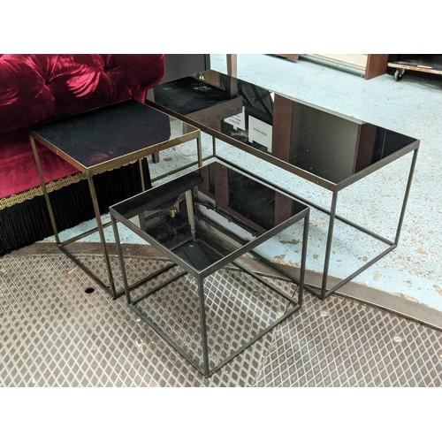 409 - LOW TABLES, a graduated set of three, 105cm x 43cm sq. at largest, bronze metal, black glass tops. (... 