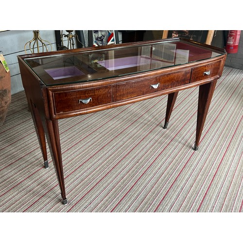 195 - BIJOUTERIE TABLE, 115cm W x 76cm H x 47cm D Art Deco manner with a glass top above three drawers on ... 