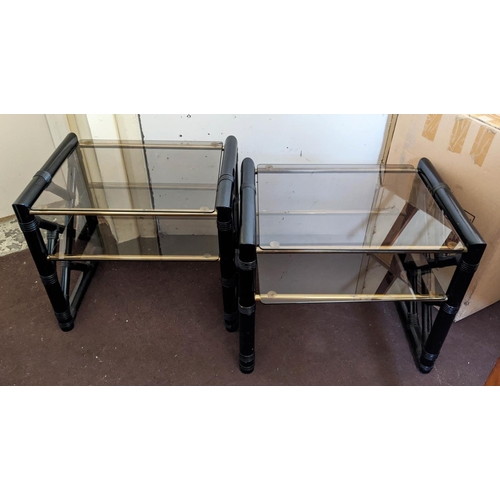 207 - LAMP TABLES, a pair, ebonised frames with cane work embellishments, two tier form with glass shelves... 