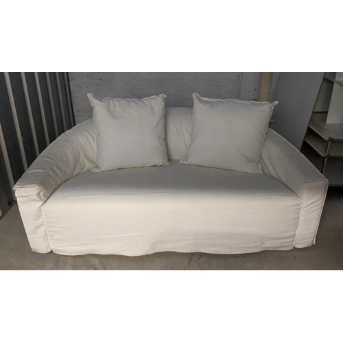 418 - POLIFORM SOFA, of curved form, in a loose white cover, 180cm W.